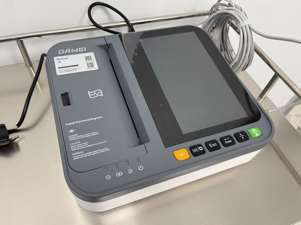 A digital electrocardiograph on a stainless steel trolley