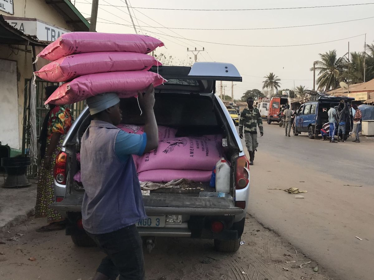Humanitarian staff distributing rice donations during disaster relief in The Gambia