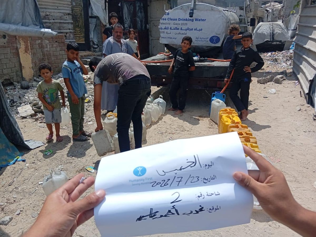 A dated Humanity First delivery log held up at a water trucking point in Gaza
