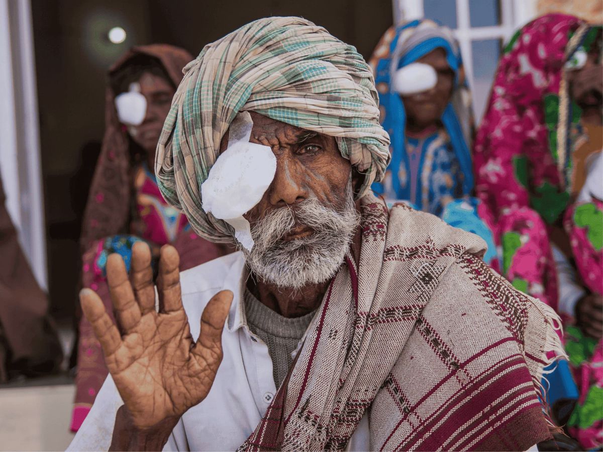 A man waving after eye treatment through the Gift of Sight programme