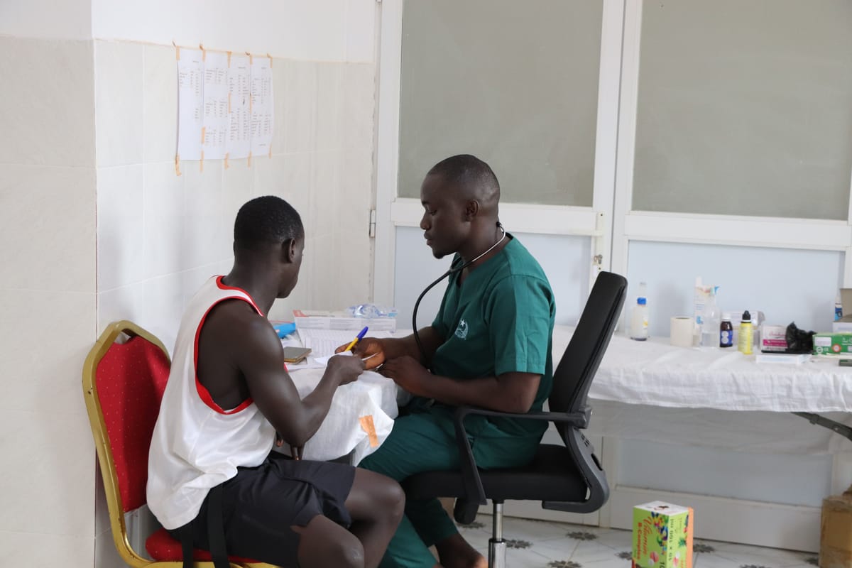 A doctor examining a patient at the Bissau clinic