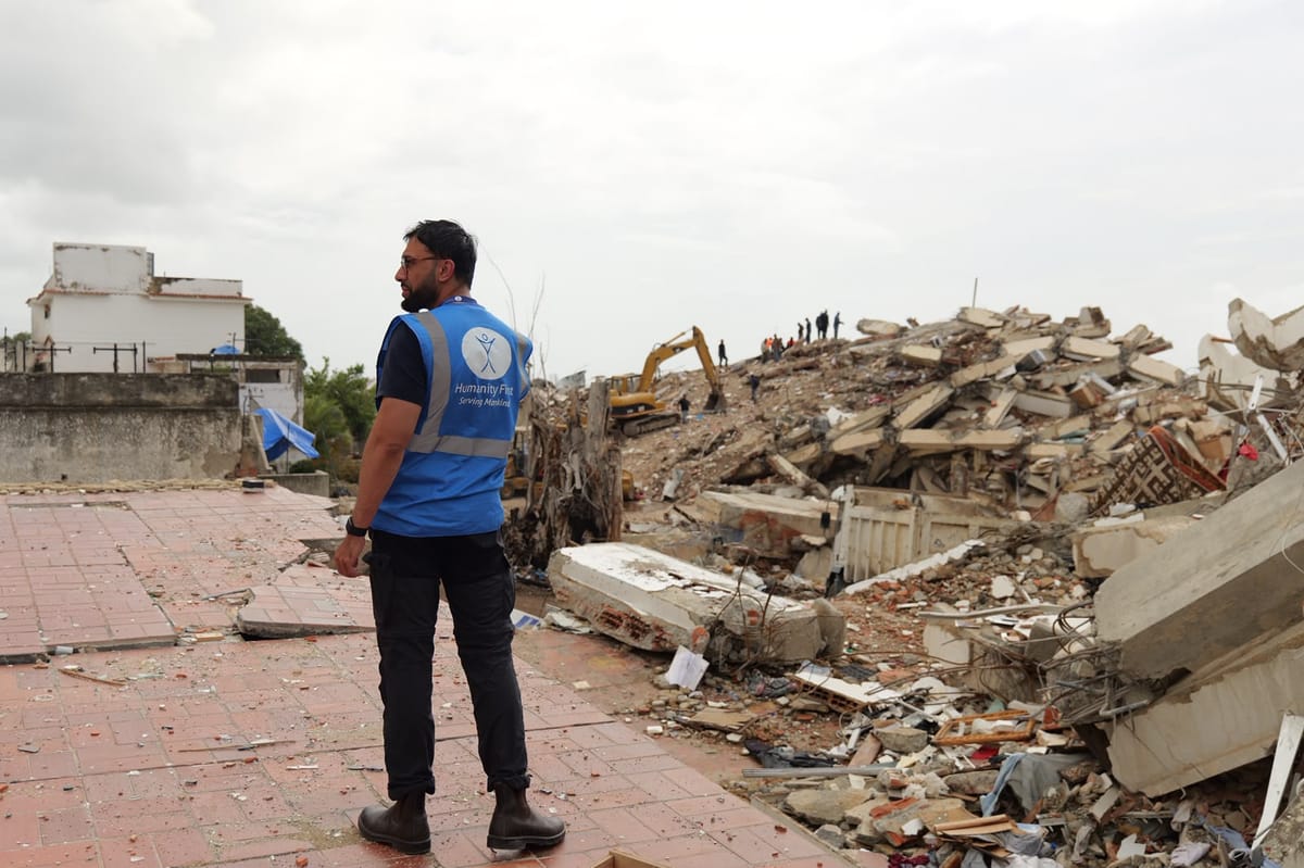 A Humanity First worker amid the earthquake damage in La Guaira