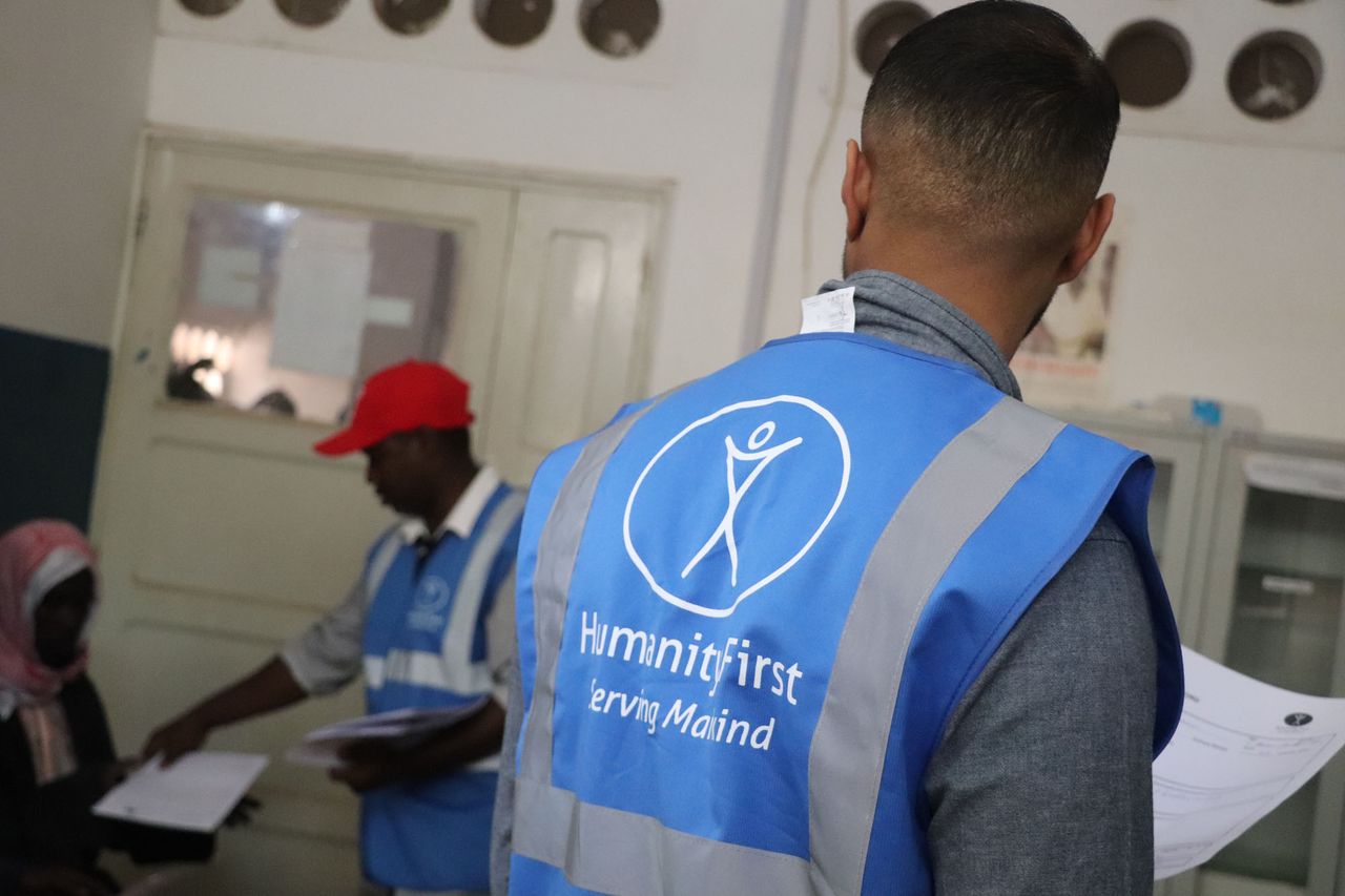 A Humanity First UK volunteer in a branded vest