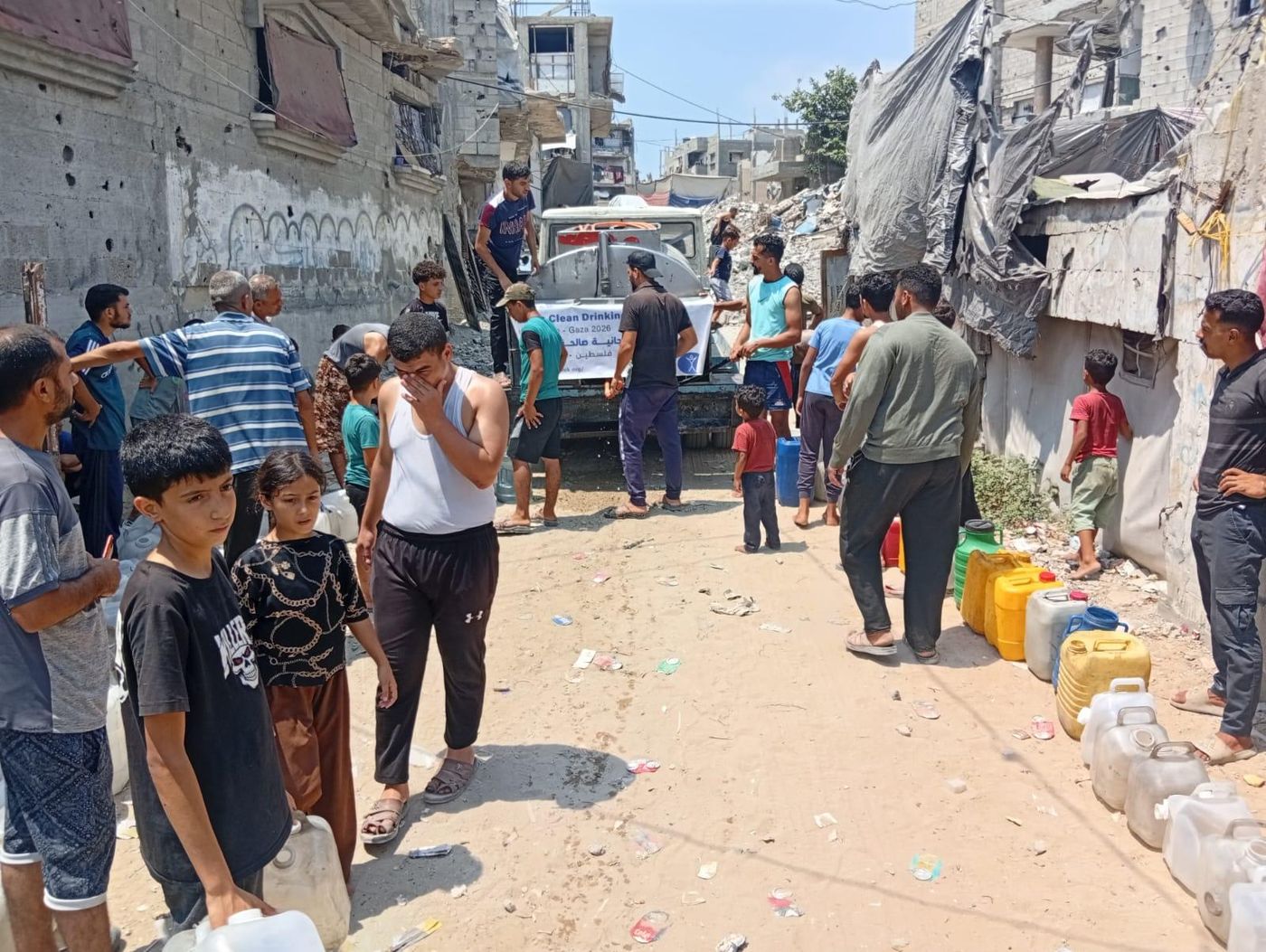 Families collecting clean water from a Humanity First truck in northern Gaza