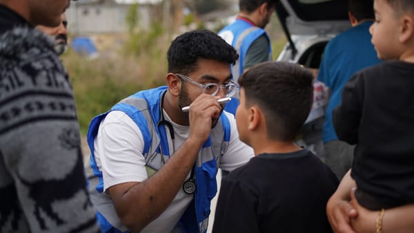 A Humanity First UK medic checking a patient's eye
