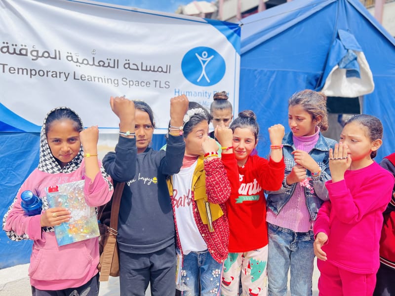 Children studying at a learning site in Gaza