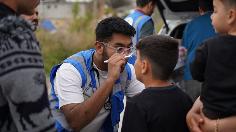 A Humanity First UK medic checking a patient's eye after the Türkiye earthquake