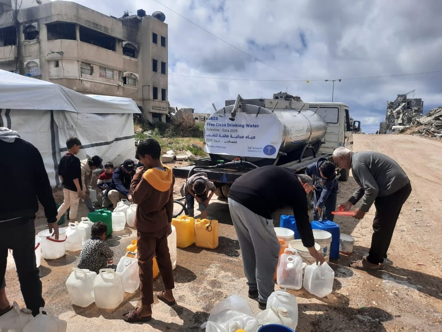 A Humanity First water tanker distributing clean water in a destroyed area of Gaza